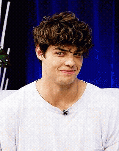 A Young Man With Curly Hair Wearing A White T-Shirt GIF