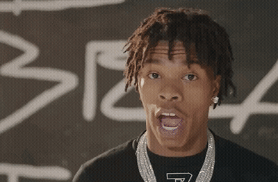 A Young Man With Dreadlocks Is Wearing A T-Shirt That Has The Letter T On It GIF