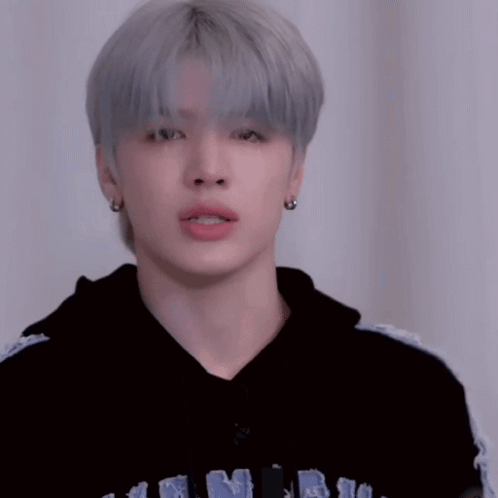 A Young Man With Gray Hair Is Wearing A Black Hoodie And Making A Funny Face GIF