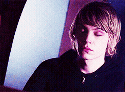 A Young Man With His Eyes Closed Is Wearing A Black Jacket GIF