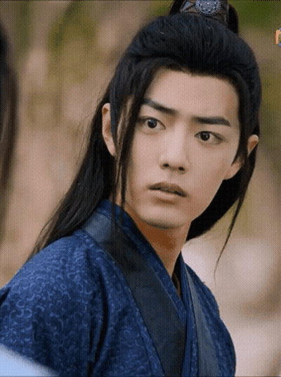 A Young Man With Long Black Hair Is Wearing A Blue Kimono GIF