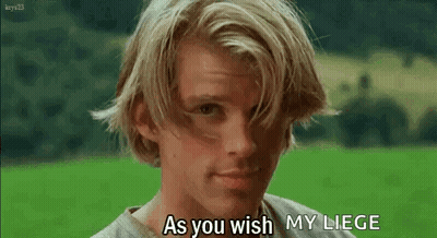A Young Man With Long Blonde Hair Is Standing In A Field And Says `` As You Wish My Liege '' . GIF