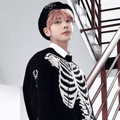 A Young Man With Pink Hair Is Wearing A Skeleton Sweater GIF