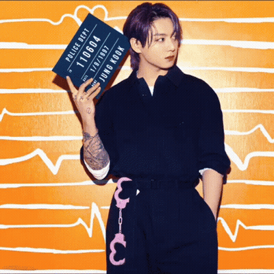 A Young Man With Purple Hair Is Holding Up A Police Department Mug Shot GIF