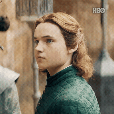 A Young Man With Red Hair And Blue Eyes Is Wearing A Green Jacket GIF