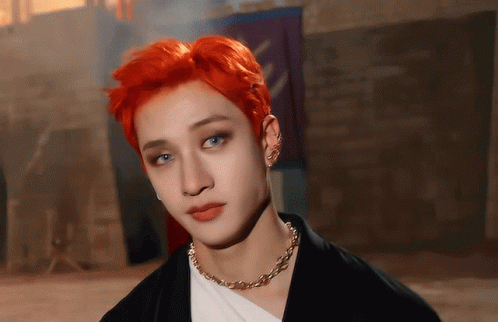 A Young Man With Red Hair And Blue Eyes Wearing A Necklace GIF