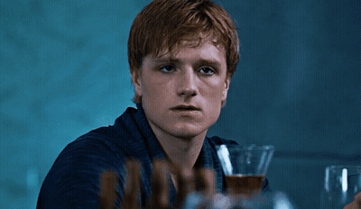 A Young Man With Red Hair Is Holding A Glass Of Wine GIF