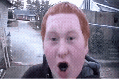A Young Man With Red Hair Is Making A Funny Face GIF
