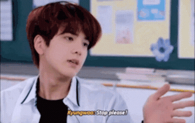A Young Man With Red Hair Is Sitting In A Classroom Talking To Someone . GIF
