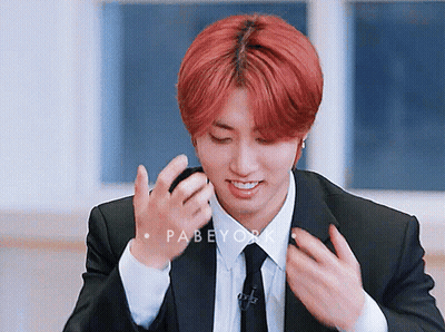 A Young Man With Red Hair Is Wearing A Suit And Tie .. GIF