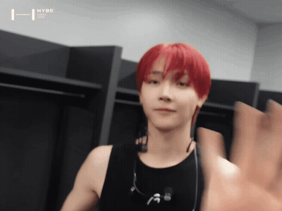 A Young Man With Red Hair Is Wearing Headphones And A Black Tank Top GIF