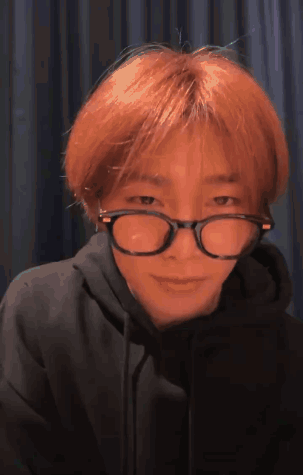 A Young Man With Red Hair Wearing Glasses And A Black Hoodie . GIF