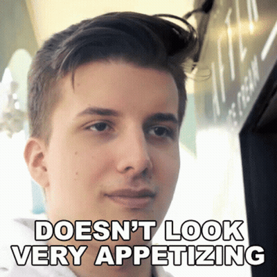 A Young Man With The Words Does N't Look Very Appetizing Above His Face GIF