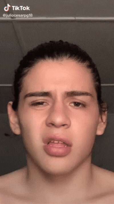 A Young Man Without A Shirt Is Making A Funny Face With A Tik Tok Watermark GIF