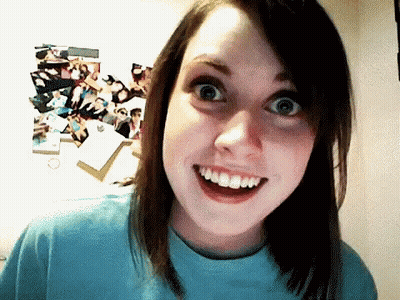A Young Woman In A Blue Shirt Is Smiling With Her Mouth Open GIF