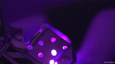 A Zippo Lighter Is Lit Up With Purple Light And The Words Pink Collapse Below It GIF