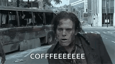 A Zombie Is Running Down A City Street With A Bus In The Background And Says `` Coffee '' . GIF