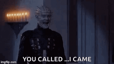 A Zombie Is Screaming And Saying `` You Called ... I Came '' While Standing In A Dark Room . GIF