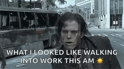 A Zombie Is Walking Down A Street In A City . GIF