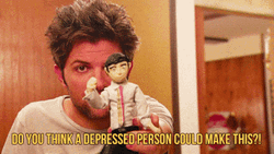 Adam Scott Holding A Toy GIF