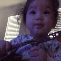 Adorable Baby Playing Butterfly Knife GIF