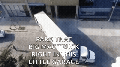 Aerial View Big Mac Truck Parked In Little Garage GIF