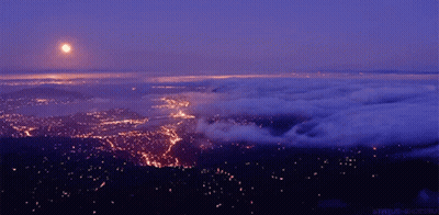 Aerial View City At Night With Full Moon GIF