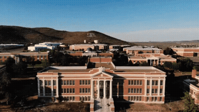 Aerial View Of Brick Building With Mountain And Letter S GIF