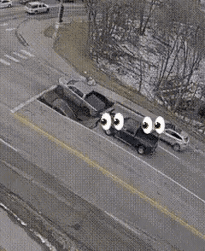 Aerial View Of Car With Eyes Driving Down Road GIF