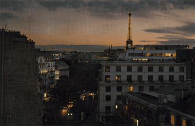 Aerial View Of City At Night With Eiffel Tower Lit Up GIF