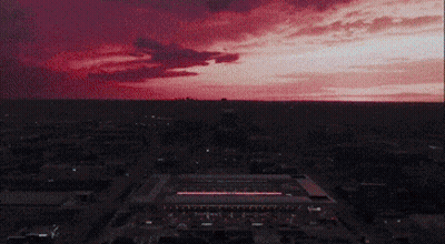 Aerial View Of City At Night With Red Sky GIF