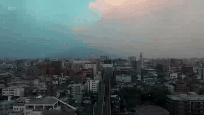 Aerial View Of City At Sunset With Train GIF