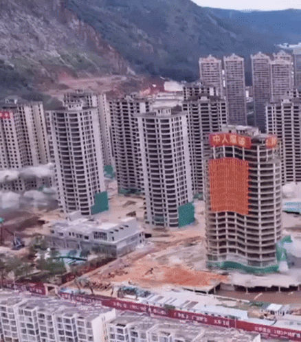 Aerial View Of City With Tall Buildings And Chinese Sign GIF