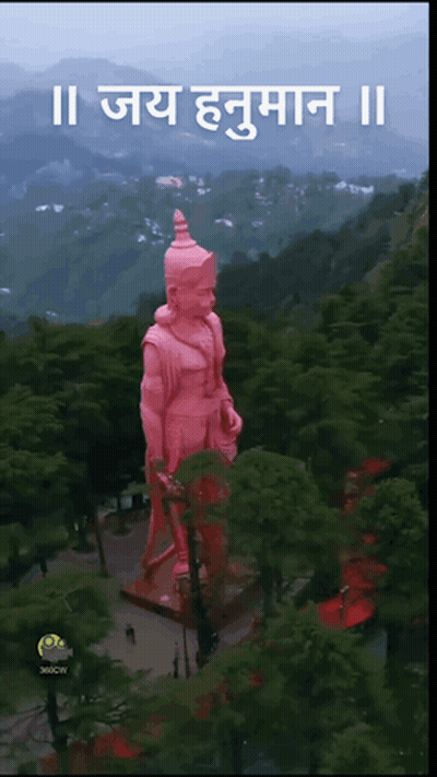 Aerial View of Hanuman Statue in Forest With Mountains
