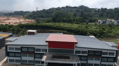 Aerial View Of Large Building With Red And Black Roof GIF