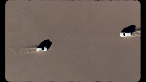 Aerial View Of Two Cars Driving Through The Sand GIF