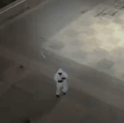 Aerial View Person In White Suit Walking Down Street GIF