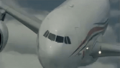 Airplane Flying Through Sky GIF