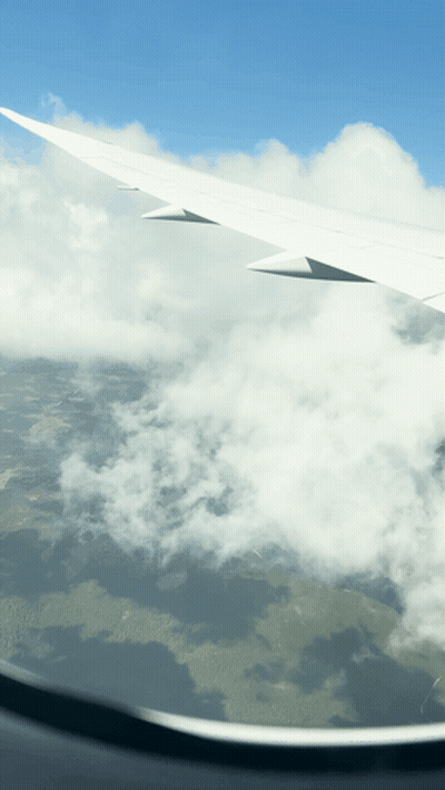 Airplane Wing Flying Through Clouds GIF