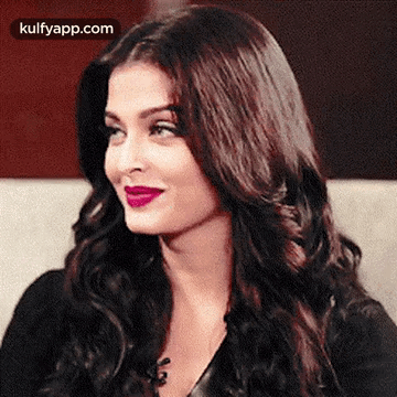 Aishwarya Rai Is Wearing A Black Top And Purple Lipstick . GIF