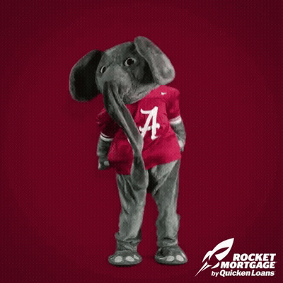 Alabama Mascot Standing In Front Of Red Background Saying Alabama Wins GIF