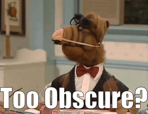 Alf From The Show Sits At A Table With The Words Too Obscure Written Below Him GIF