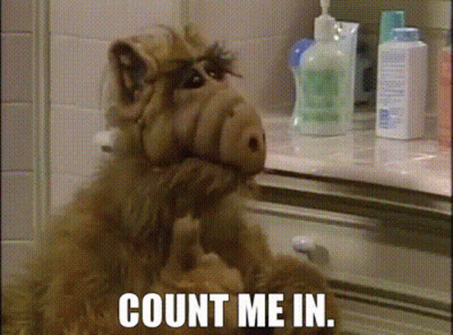 Alf From The Sitcom Sits In Front Of A Counter With The Words Count Me In Written On It GIF