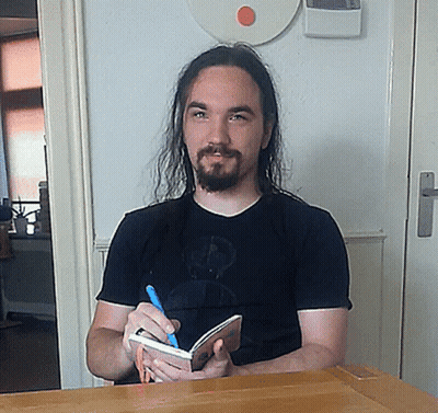 ALF Sitting At Desk With Pen GIF