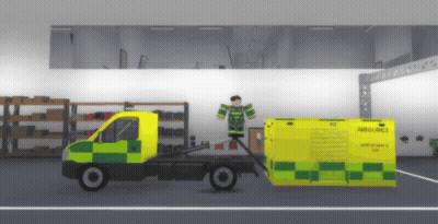 Ambulance Being Pulled By Truck In Garage GIF