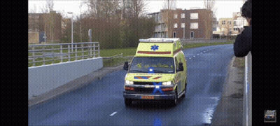 Ambulance Driving Down Street With License Plate XS-KZP GIF