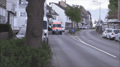 Ambulance Driving Past Store Saying Rie GIF