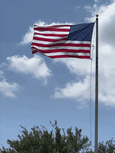 American Flag Flying In Cloudy Blue Sky GIF