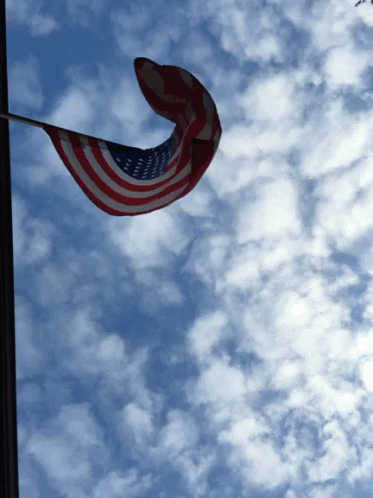 American Flag Flying In Wind Against Cloudy Sky GIF