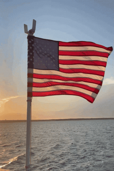 American Flag Over Water At Sunset GIF